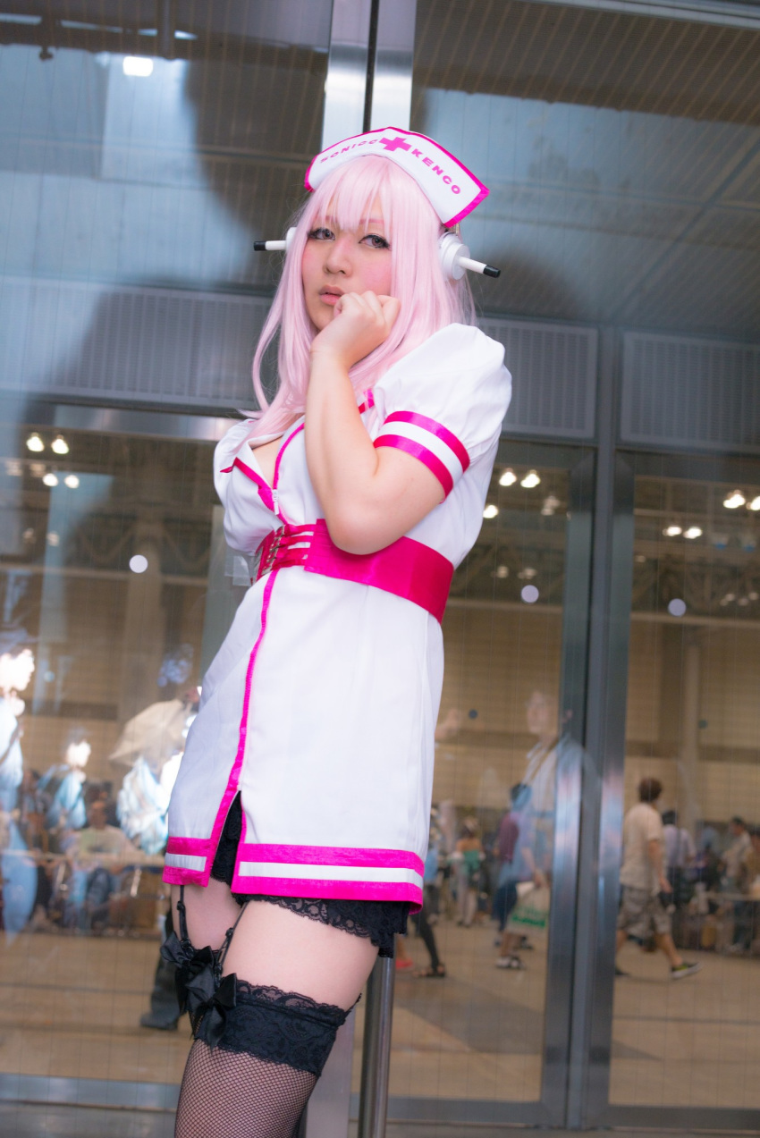 1girl asian breasts cosplay dress female garter_straps headphones japanese long_hair nurse pink_hair solo super_sonico