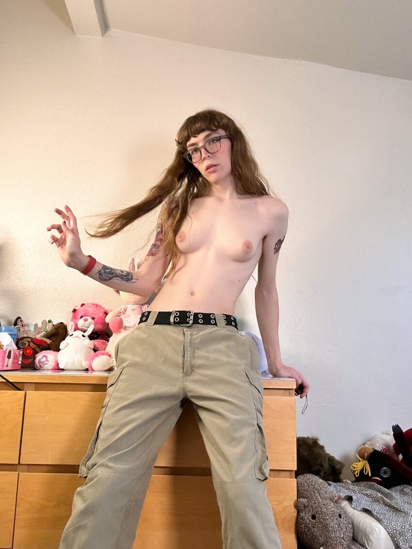 1trans belt breasts brookie brown_hair cargo_pants glasses looking_at_viewer pants playing_with_hair small_breasts sourced tattoo topless trans_female transgender