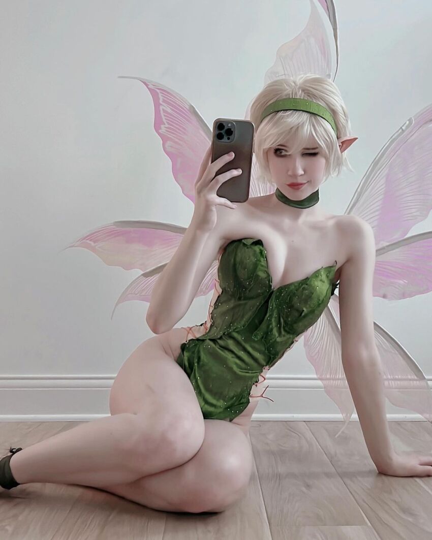 1girl bare_shoulders blonde blonde_female blonde_hair caucasian caucasian_female choker cleavage cosplay disney elf_ears headband hip_cleavage hips norafawn on_floor pale pale-skinned_female pale_skin pointy_ears revealing_clothes selfie sitting solo solo_female solo_focus tinker_bell wings