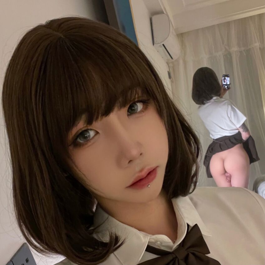 1boy asian ass brown_hair chinese femboy flaccid izayoirui lip_piercing lipstick long_hair looking_at_viewer mirror penis phone piercing selfie skirt solo tattoo testicles transgender trap