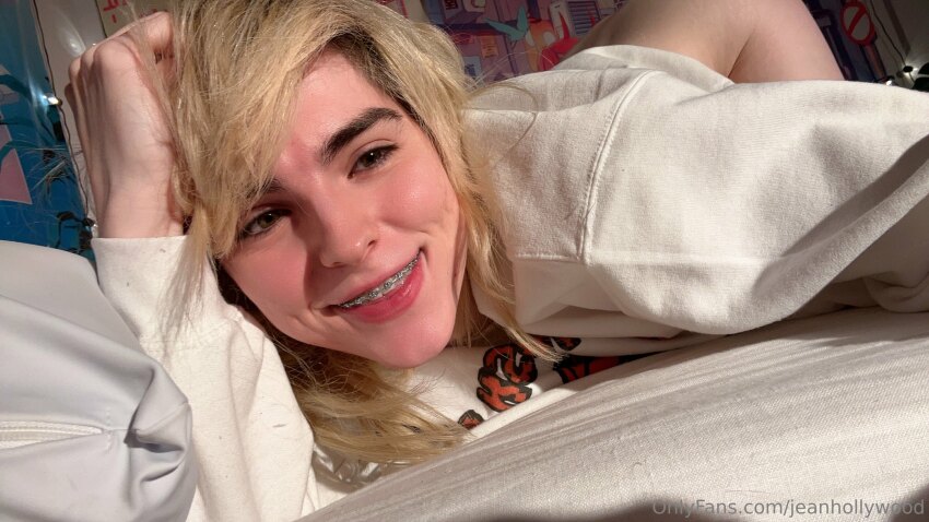 ass ass_up blonde_hair bottomless braces ella_hollywood femboy jean_hollywood looking_away on_bed onlyfans pornstar selfie smile watermark white