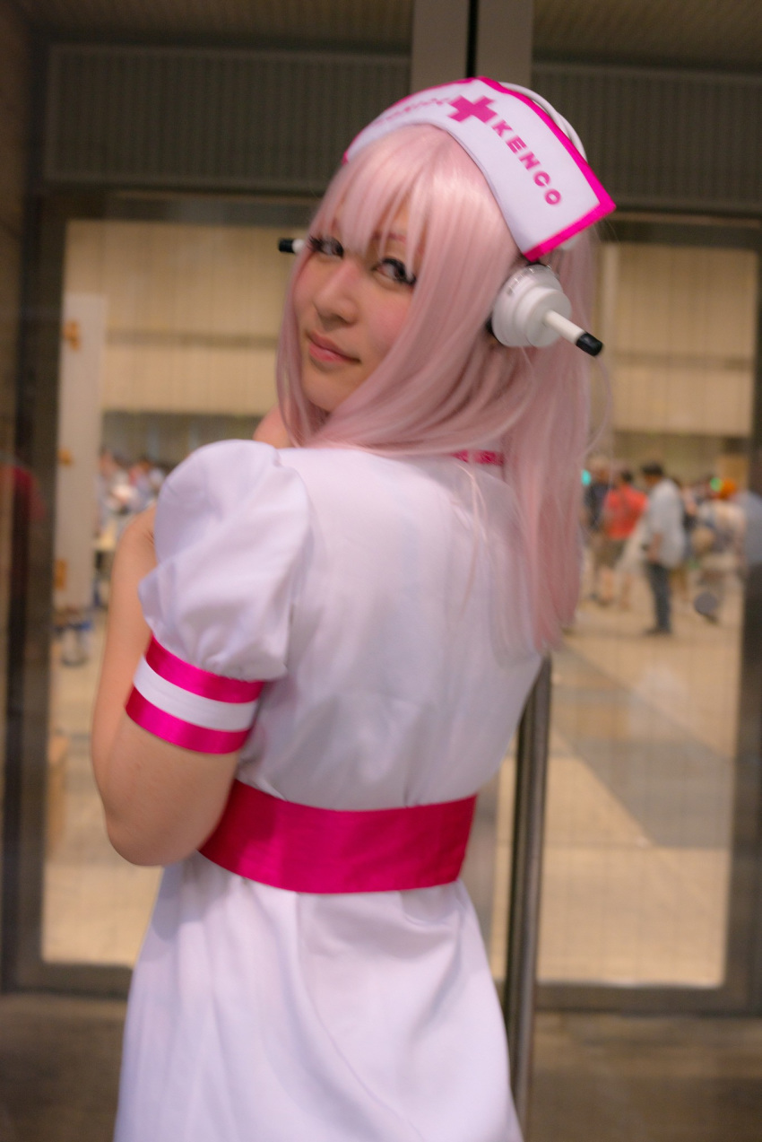 1girl asian breasts cosplay dress female headphones japanese long_hair nurse pink_hair solo super_sonico