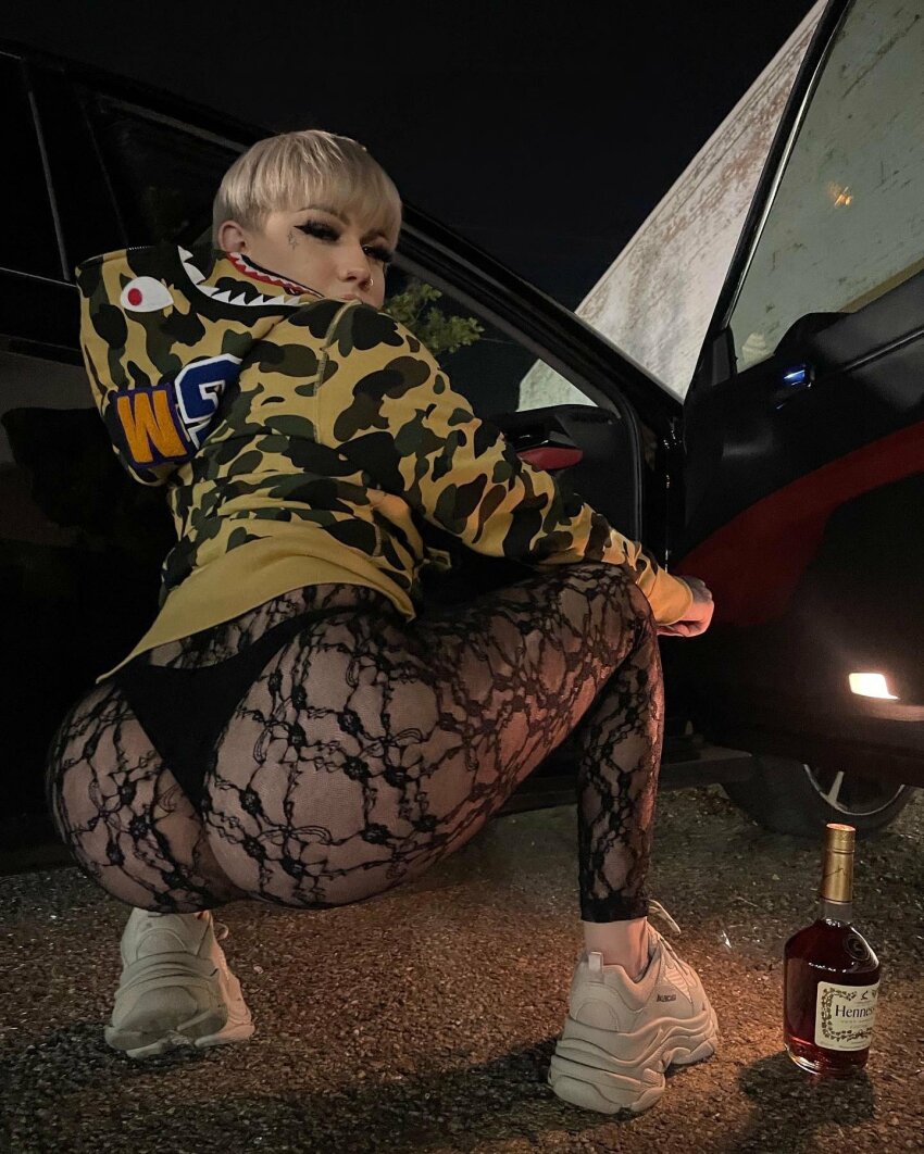 alcohol ass balenciaga big_ass blonde_hair car clothed dat_ass face_tattoo femboy from_below hennessey hispanic hoodie latino leggings looking_at_viewer looking_back non-nude outside playboyzach posing presenting_ass round_ass see-through short_hair sneakers solo tattoo thong white