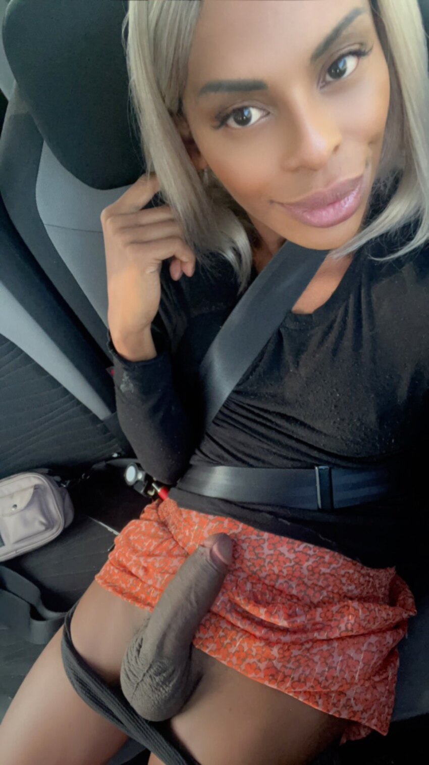 1shemale balls blonde_hair breasts brown_eyes car car_interior clothed clothing dark-skinned_shemale dark_skin erection kiki_shemale long_hair looking_at_viewer penis pose public revealing_clothes selfie shemale_only small_breasts smile solo vehicle