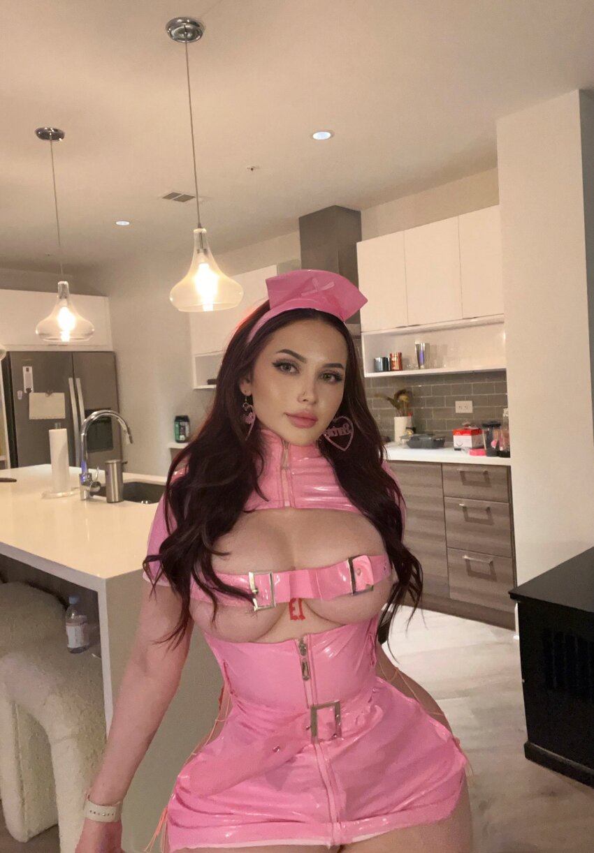 1girl caucasian caucasian_female cleavage facing_viewer female female_only latex looking_at_viewer makeup nurse_outfit pink_latex_dress tattoo tayler_hills twitter