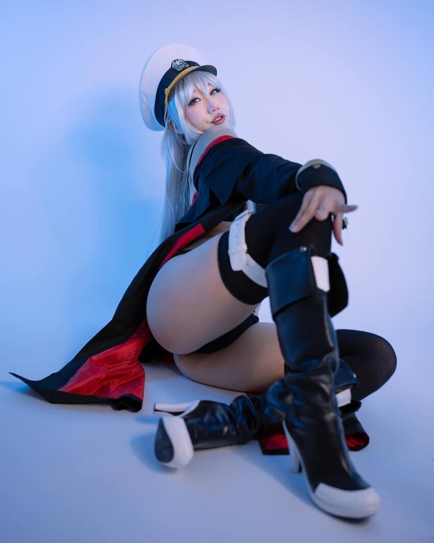 1girl asian ass azur_lane cape cosplay danisaurz enterprise_(azur_lane) high_heel_boots high_heels silver_hair sitting solo thighs