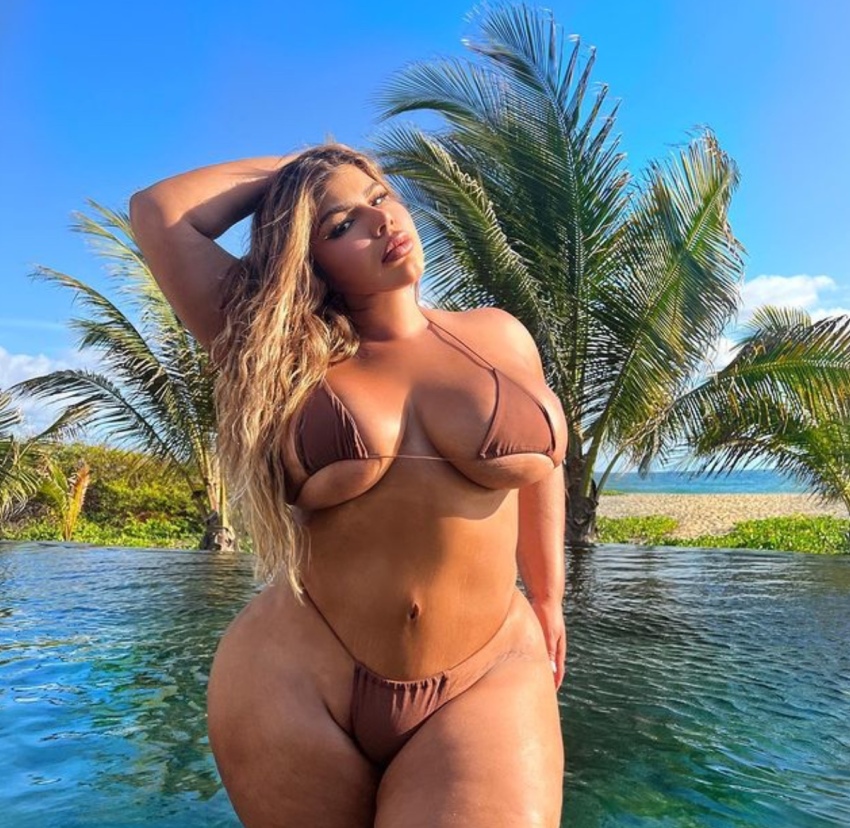 1girl amateur arm_up bbw big_breasts bikini blonde_hair breasts chubby cleavage curvy fake_lips female female_only hand_on_head huge_breasts instagram latina legs long_hair looking_at_viewer micro_bikini milf navel non-nude outdoors parted_lips pool posing sexy shell_raven solo sourced standing stomach tan_skin thick thick_thighs thong water wide_hips