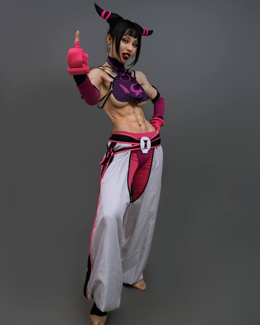 1girl abs asian bangs belt black_hair breasts capcom chinese clothed cosplay detached_sleeves earrings fake_breasts feet female female_only fingerless_gloves gloves grey_background hair_horns halterneck hand_on_hip instagram juri_han large_breasts lipstick middle_finger midriff muscle muscular_female navel pants red_lipstick serratus_anterior sideboob sidelocks simple_background solo standing street_fighter toeless_socks toes tongue tongue_out underboob yuan_herong