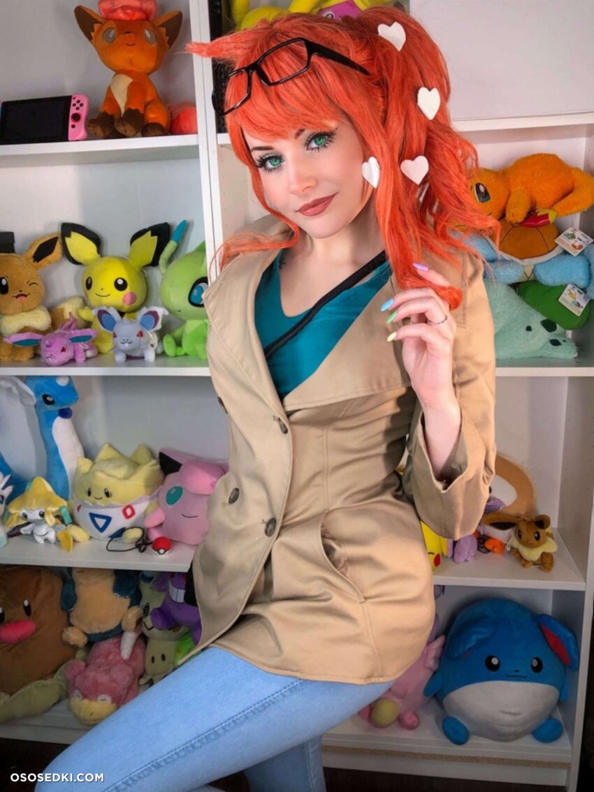 1girl brown_jacket clothed clothed_female green_eyes green_shirt hair_twirl hearts jacket jeans nail_polish nintendo_switch orange_hair photo photoshoot plushie pokemon red_hair redhead sonia_(pokemon) sunglasses