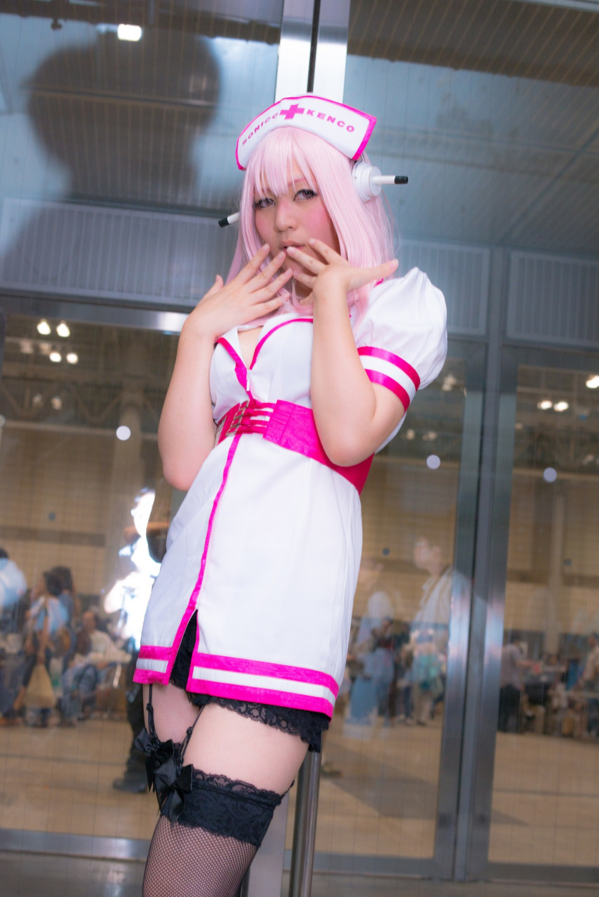 1girl asian breasts cosplay dress female headphones japanese long_hair nurse pink_hair solo super_sonico