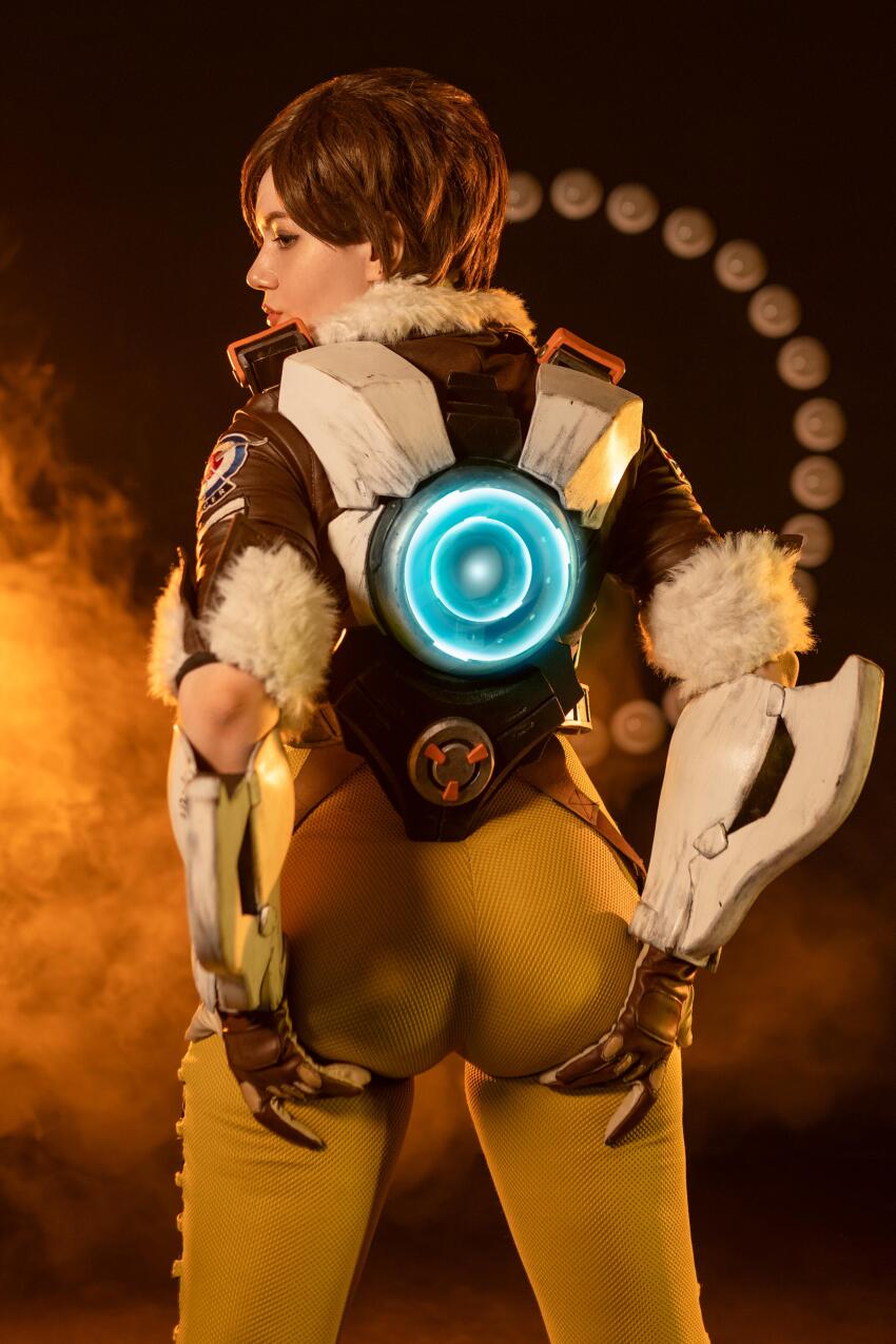 1girl alina_becker ass ass_focus back back_view backside blizzard_entertainment booty brunette butt clothed clothed_female cosplay dark_hair dark_haired_female female_focus female_only form_fitting from_behind grabbing_ass leggings non_nude overwatch photo sexually_suggestive sfw skin_tight solo solo_female solo_focus sourced suggestive tight_clothes tracer_(overwatch)