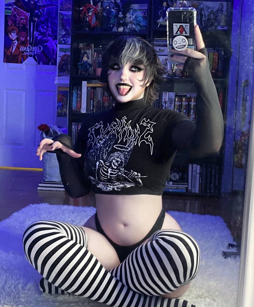 1girl black_hair black_lipstick cellphone female goth kalaynokay legs_crossed lipstick mirror_selfie navel pale_skin selfie solo striped_legwear tagme thighhighs tongue_out two_tone_hair white_hair