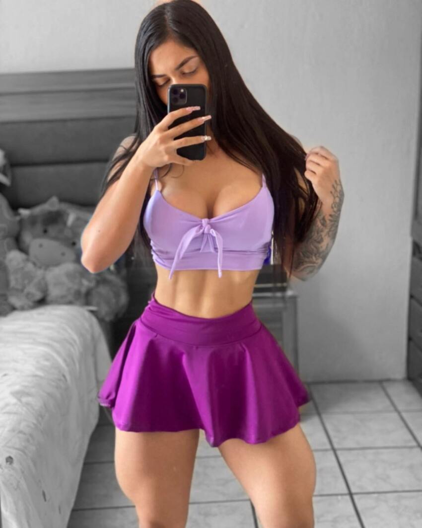 1girl arm_tattoo breasts brown_hair female large_breasts large_thighs long_hair midriff mirror_selfie muscular_female purple_skirt skirt standing thick_thighs