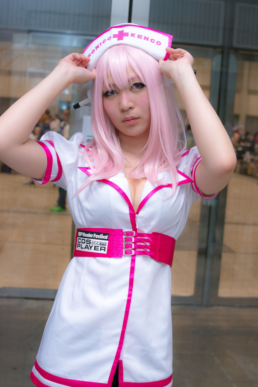 1girl asian breasts cleavage cosplay dress female headphones japanese long_hair nurse pink_hair solo super_sonico