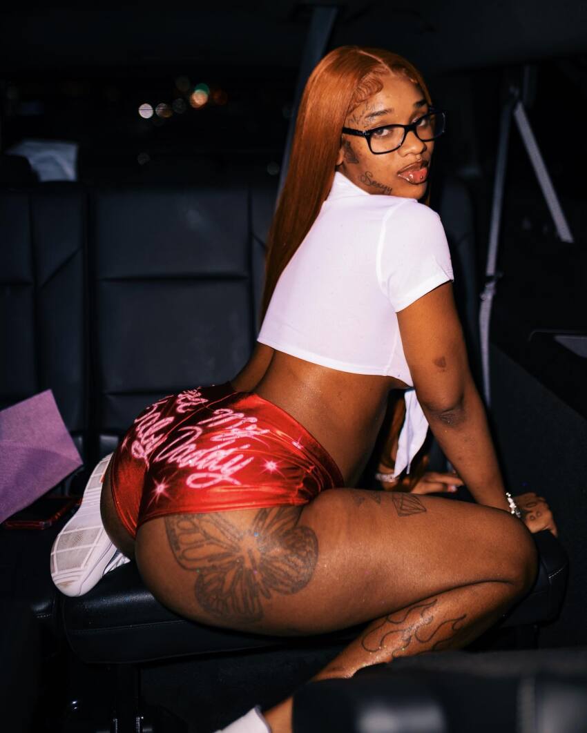 1girl ass black black_female car celebrity clothed clothed_female dark-skinned_female dark_skin female female_focus female_only female_solo glasses long_hair looking_back sexyy_red solo solo_female solo_focus tattoo tattoo_on_ass tattoo_on_leg tattoos