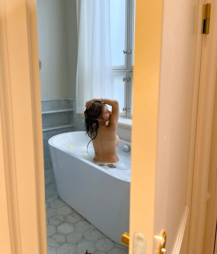 1girl asian ass back bath bathroom bathtub breasts brown_hair completely_nude doorway female female_focus female_only female_solo kiaraakitty long_hair looking_back medium_breasts nude playing_with_hair sideboob solo solo_female solo_focus voyeur wet wet_body wet_hair