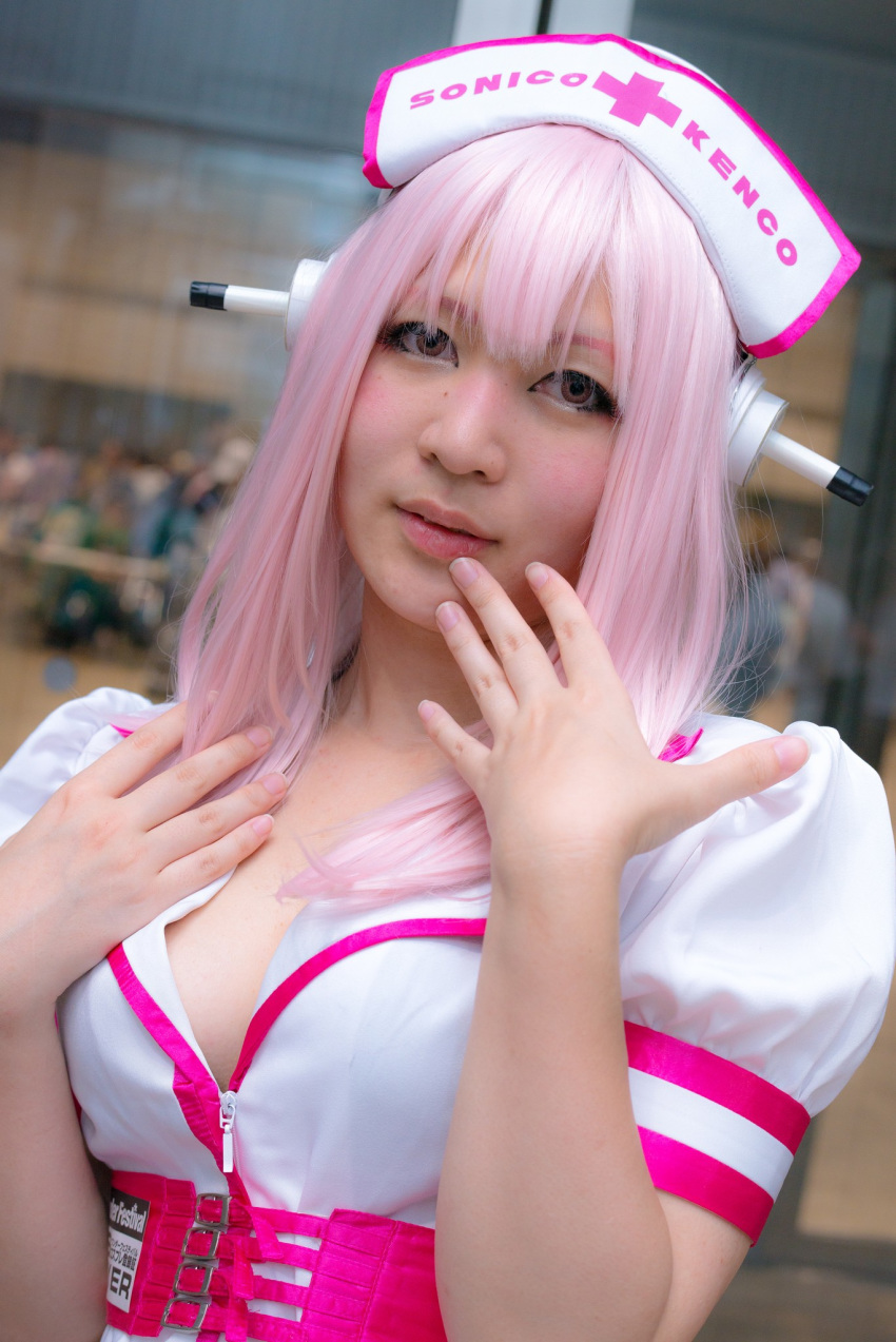 1girl asian breasts cosplay dress female headphones japanese long_hair nurse pink_hair solo super_sonico