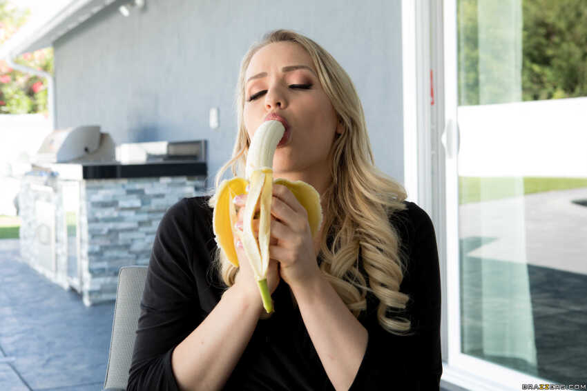 2018 banana blonde_hair brazzers eyes_closed female female_only food_play fruit good highres light-skinned_female long_hair makeup mia_malkova non-nude oral_insertion oral_insinuation outdoors photo pornstar pornstars_like_it_big sexually_suggestive sfw solo solo_female solo_focus sucking_banana wavy_hair white_female