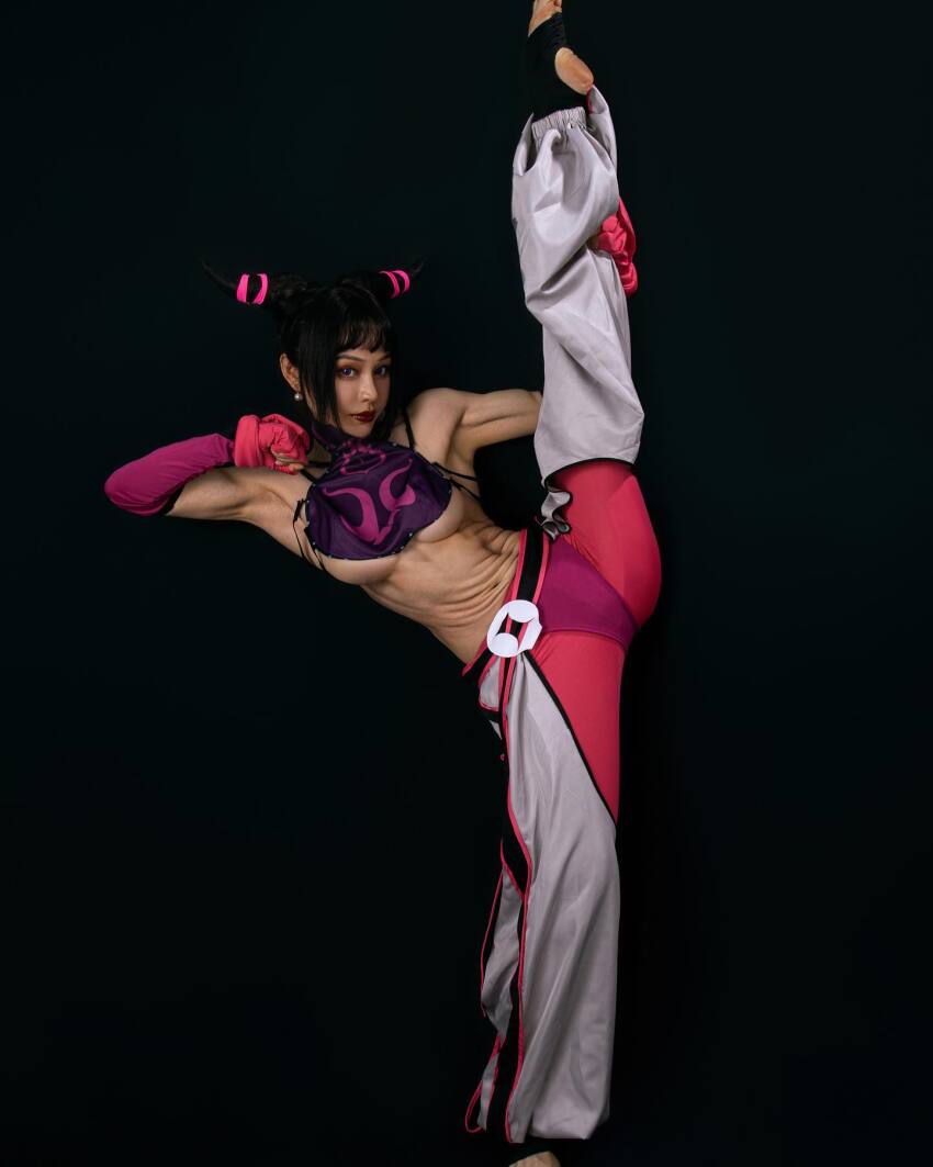 1girl abs asian bangs black_background black_hair breasts capcom chinese clothed cosplay detached_sleeves earrings fake_breasts feet female female_only fingerless_gloves flexible gloves hair_horns halterneck instagram juri_han large_breasts lipstick looking_at_viewer midriff muscle muscular_female navel pants red_lipstick sidelocks simple_background solo splits standing_on_one_leg standing_split stirrup_socks street_fighter toeless_socks underboob yuan_herong