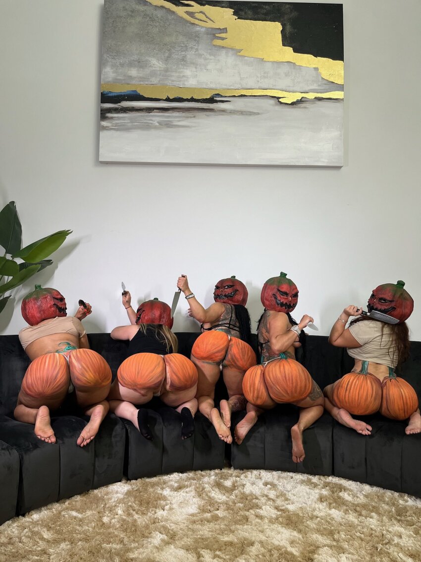 5girls black_hair blonde_hair brown_hair couch dark-skinned_female doubledosetwins halloween knife light-skinned_female looking_at_viewer looking_back painted_ass pumpkin pumpkin_ass pumpkin_head white_female