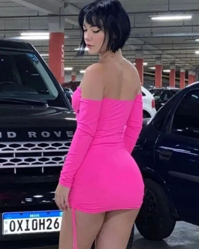 1girl ass ass_focus black_hair brazilian car jeep medium_breasts miniskirt outdoor outdoors outside parking_lot pink_skirt short_hair skirt solo solo_female truck van vehicle