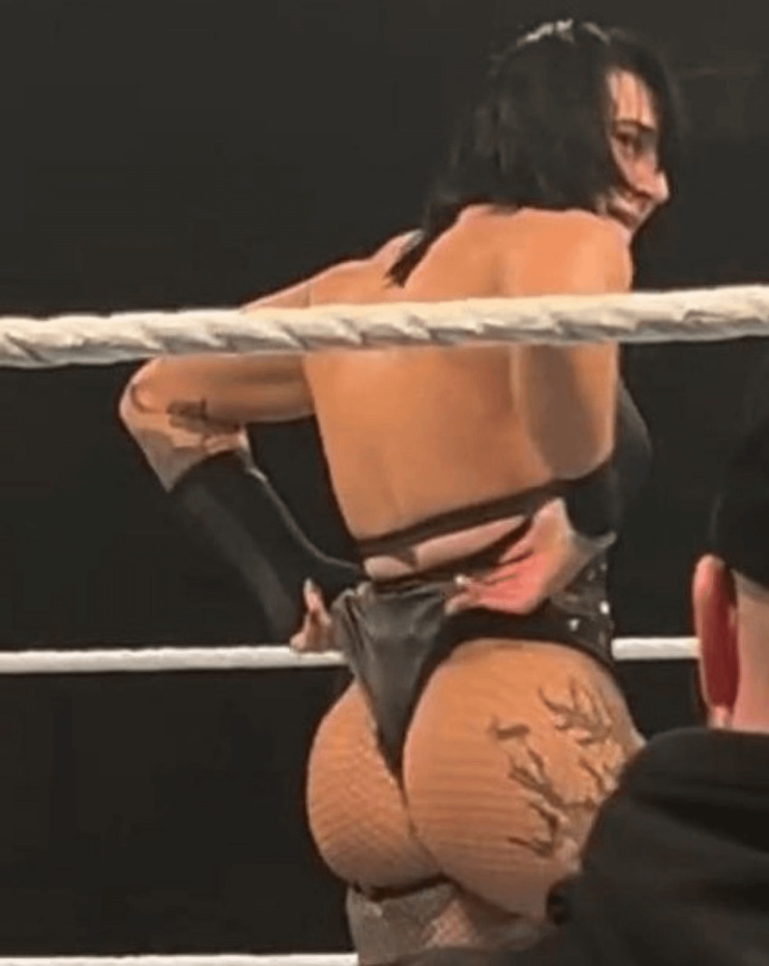 1girl ass athletic_female australian big_ass black_hair celebrity dat_ass female female_wrestler fishnets huge_ass muscular_female photo rhea_ripley wrestler wrestling wrestling_attire wwe