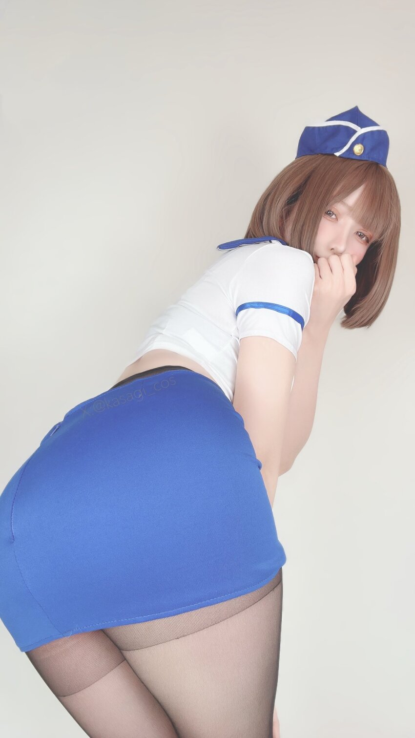 1girl ass ass_focus brown_hair flight_attendant legs medium_hair miniskirt pantyhose short_hair skirt uniform