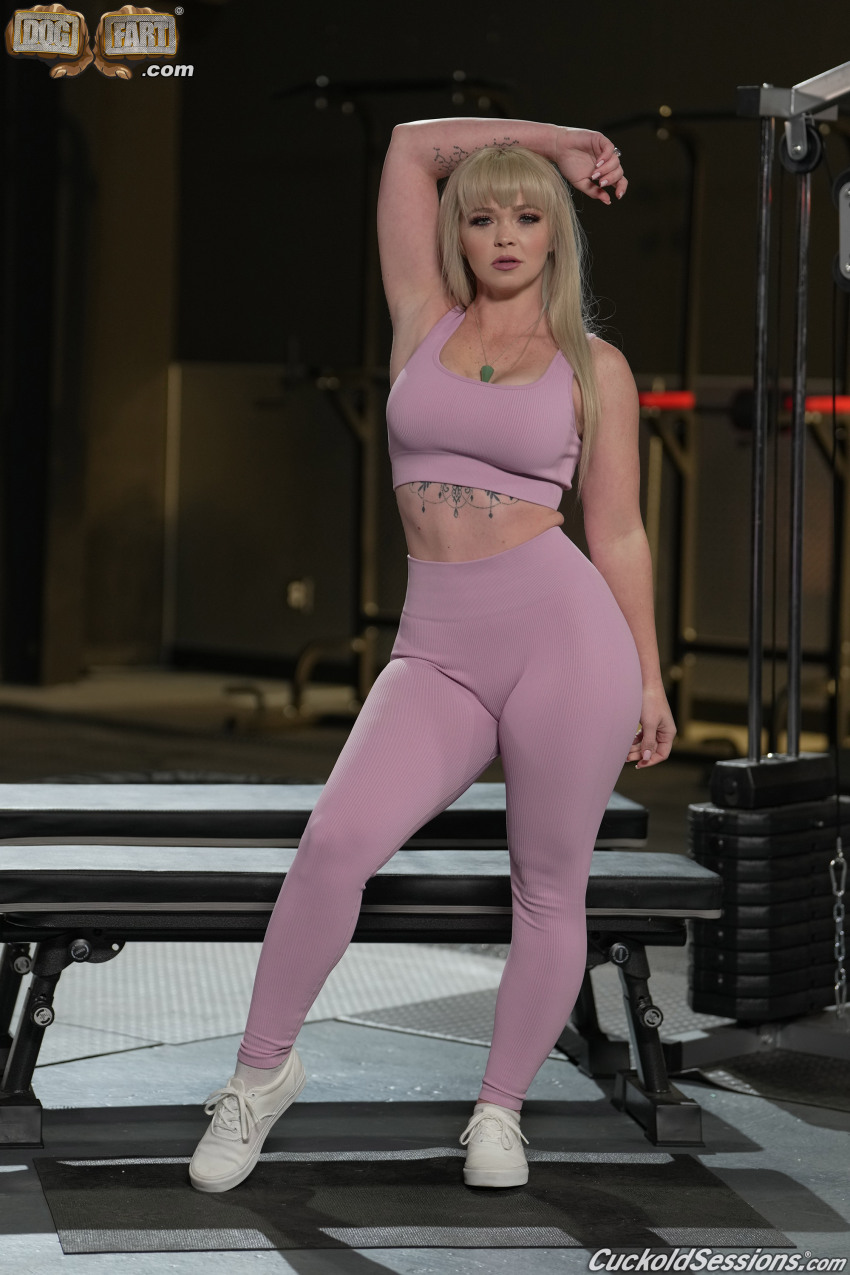 1girl arm_raised blonde blonde_female bra european european_woman indoors leggings looking_at_viewer pawg pink_bra pink_legwear shoes standing tattoo watermark white white_female yoga_pants