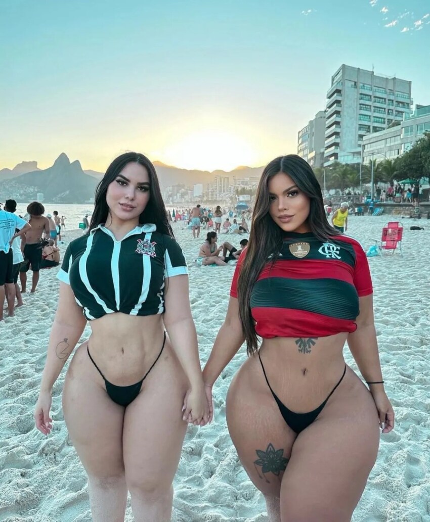 2girls beach bikini bikini_bottom_only black_bikini black_eyes black_hair blue_sky bracelet brazilian breasts clothing crop_top cropped_shirt curvaceous curves day female flower_tattoo graciebon highleg highleg_bikini holding_hands jewelry large_breasts latina leg_tattoo lips long_hair looking_at_viewer midriff multiple_boys multiple_girls navel ocean outdoors pantsu parted_bangs parted_hair red_shirt shirt sky smile standing stomach swimsuit tattoo thick_thighs thighs thong underwear victoria_matosa walking water wide_hips