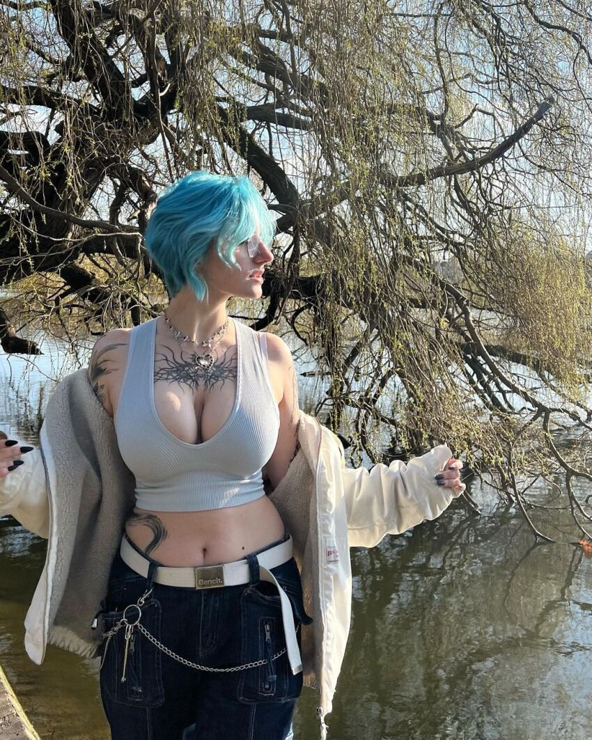 1girl blue_hair cleavage clothed_female glasses instagram jeans looking_away lyracr0w0 navel pale_skin short_hair sourced tagme tattoo tattooed_girl tree