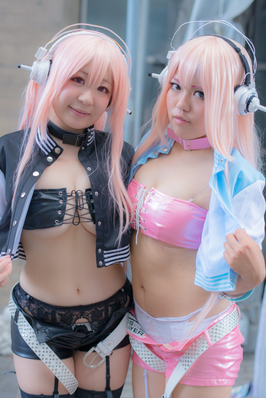 2girls asian belt breasts cleavage collar cosplay female garter_belt headphones hotpants large_breasts lingerie long_hair midriff multiple_girls navel pink_hair shorts super_sonico thighhighs