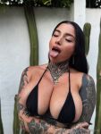 1girl andeemind big_breasts black_hair bra breasts cleavage ear_piercing earrings eyes_closed fake_nails female female_focus female_only female_solo lipstick long_hair makeup necklace onlyfans open_mouth piercing selfie solo tattoo text tongue tongue_out watermark