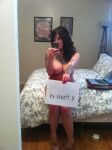 1girl bed big_breasts breasts holding_sign nipples selfie sign sitting