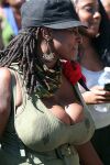 1girl breasts candid cleavage dark-skinned_female dreadlocks earrings female hat large_breasts photo poking_nipples public sunny wet_clothes