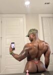 1boy ass back black_male cap dark-skinned_male dominiquedrvco gay hat male male_only muscular_male phone solo solo_male sourced tattoo thong twitter