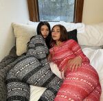 2girls ass bed bedroom black_hair breasts brown_hair clothed clothed_female female female_focus female_only long_hair looking_back lying multiple_girls on_bed sophie_rain