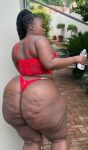 1girl ass big_ass black_hair bottomless cellulite chubby dark-skinned_female dark_skin ebony female female_focus female_only female_solo lipstick long_hair makeup massive_ass oil outside presenting_ass solo standing tattoo the_real liso thick thong