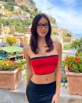 1girl asian_female athletic enhanced_breasts female glasses maily_nguyen navel_piercing tanned tube_top vietnamese