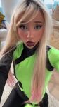 1girl black_lipstick blonde_hair braces cosplay kim_possible_(series) looking_at_viewer mouth_open oral_fixation shego shorter_than_10_seconds solo tagme tongue tongue_out vertical_video web