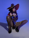 1girl black_hair cosplay covering_crotch genshin_impact hessakai mona_(genshin_impact) solo solo_female solo_focus spread_legs tongue_out watermark wig witch witch_hat