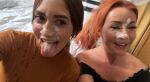 2girls after_sex artemis_carmona brown_hair clothed cum cum_on_face dyed_hair facial photo redhead smile tongue_out zoe_grey