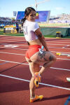 1girl ass ass_focus athlete athletic athletic_female big_ass black_hair dat_ass ewa_swoboda female looking_at_viewer looking_back outdoors polish polish_female ponytail posing smile solo standing_on_one_leg tattoo